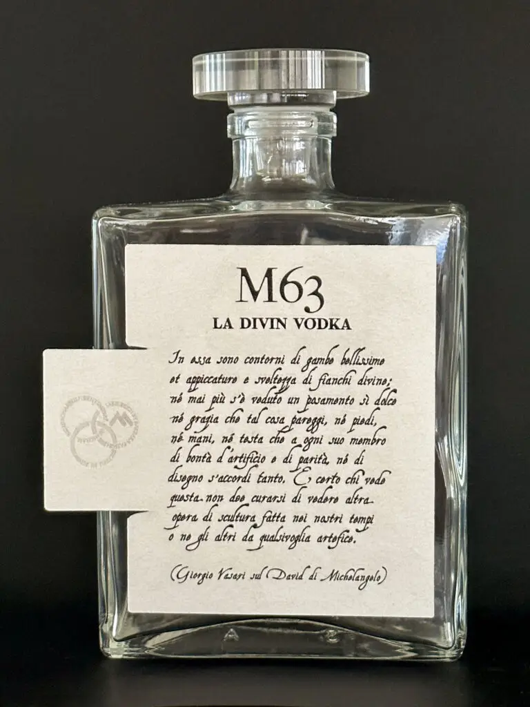 Bottiglia M63 La Divin Vodka con etichetta integra, testo calligrafico di Vasari e linguetta laterale con i tre cerchi impressi nella carta.